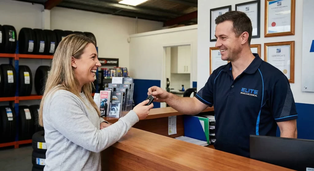 Mechanic handing keys to a happy customer at Elite Brake & Mechanical Springvale